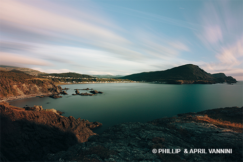 View of Trout River, Gros Morne National Park. A clear blue lake with a bright blue sky